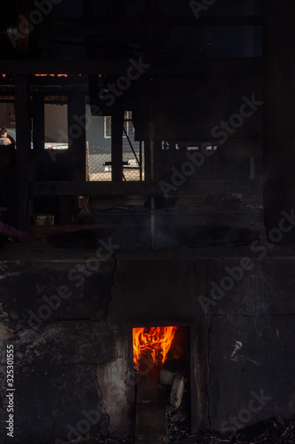 Flames roasting coffee beans at the coffee mill in Malaysia.