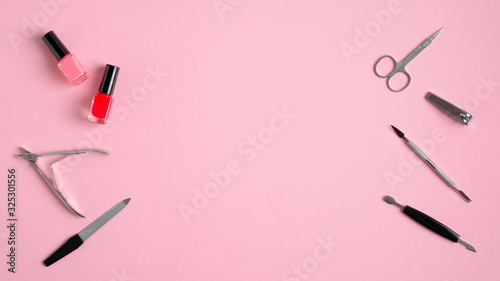 Manicure and pedicure tools on pink background. Top view with copy space. Nail salon banner design template. Beauty treatment and hand care concept