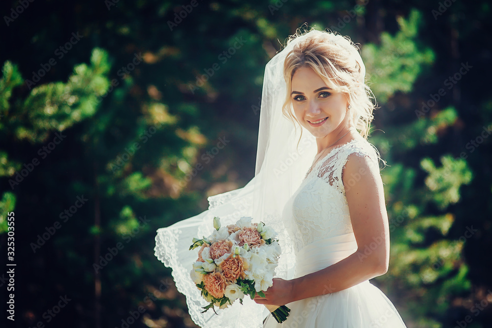 portrait of a bride with a wedding bouquet in the forest. Happy bride in white stylish dress, with a wedding bouquet, beautiful forest landscape in the background. Natural makeup, hairstyle, wreath portrait of a bride with a wedding bouquet in the forest. Happy bride in white stylish dress, with a wedding bouquet, beautiful forest landscape in the background. Natural makeup, hairstyle, wreath