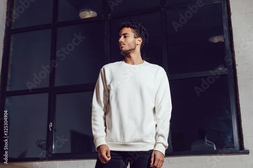 Photos Man in white blank sweatshirt. Mock-up.
