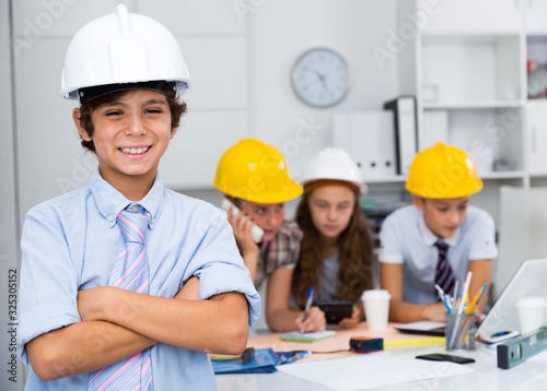 Teen boy in color helmet builder