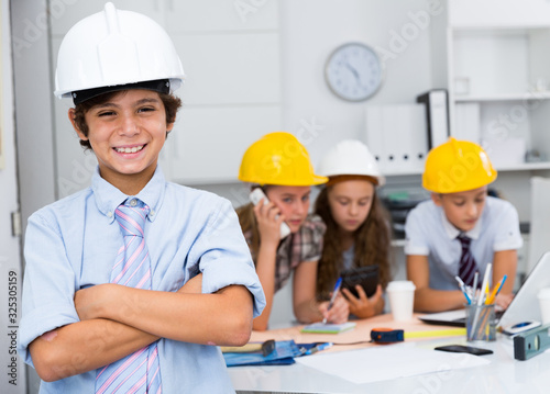 Teen boy in color helmet builder