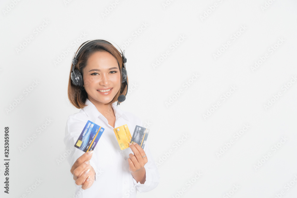 Friendly female helpline operator or call center showing blank credit card, headset holding her arms crossed isolated on white background. Friendly female helpline operator or call center showing blank credit card, headset holding her arms crossed isolated on white background.