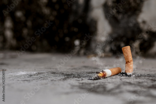 Cigarette butts on the cement floor Concept of toxic waste, not environmentally friendly.