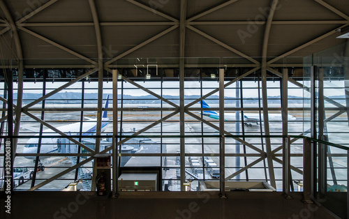 View of Empty airport terminal lounge with many airplanes. travel and commercial transport concept