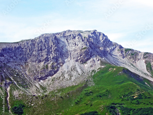 Alpine mountain peak Augstenberg over the Malbuntal alpine valley and in the Liechtenstein Alps mountain range - Malbun, Liechtenstein photo