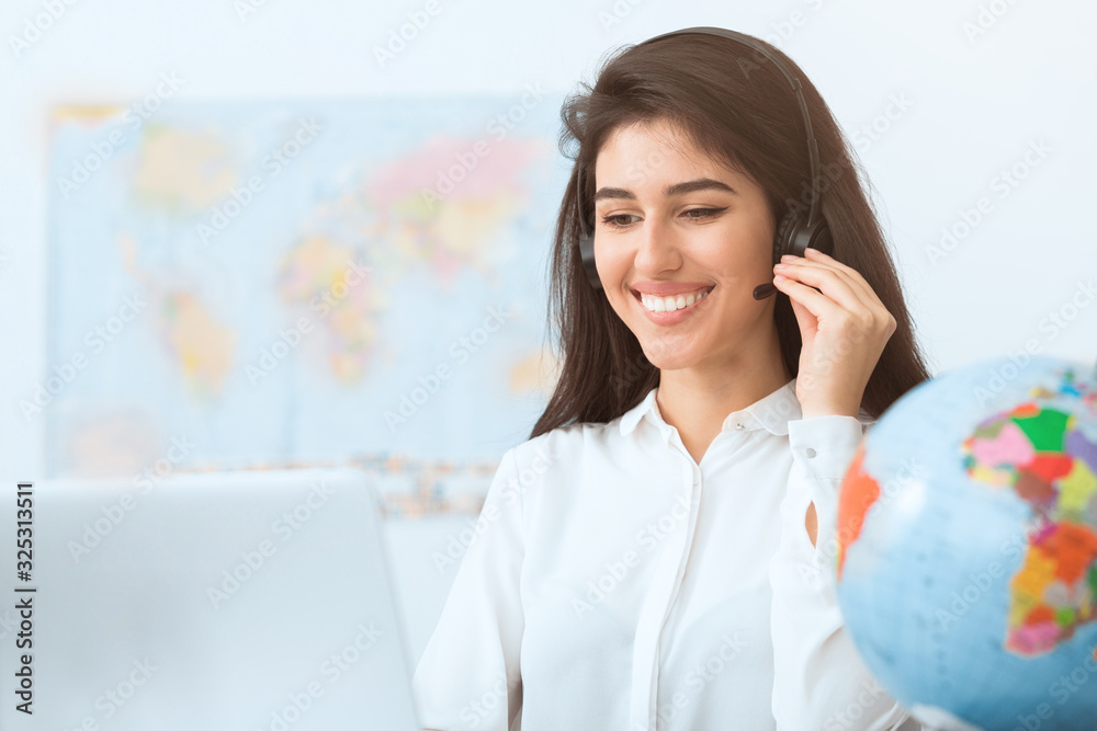 Happy travel agent speaking to customer in office Happy travel agent speaking to customer in office