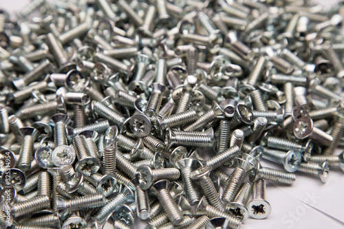  M6 metal screws galvanized white in bulk closeup in the studio
