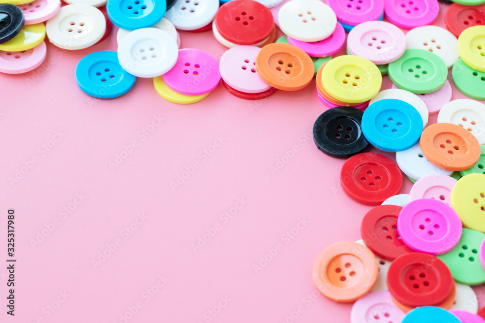 Button plastic colorful on pink background and copy space. Button plastic colorful on pink background and copy space.