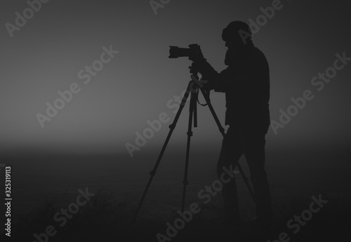 silhouette of photographer at sunset