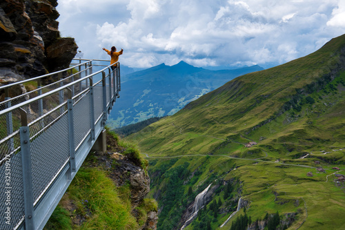 woman on top of mountain and cliff walk in first station Grindelwald photo