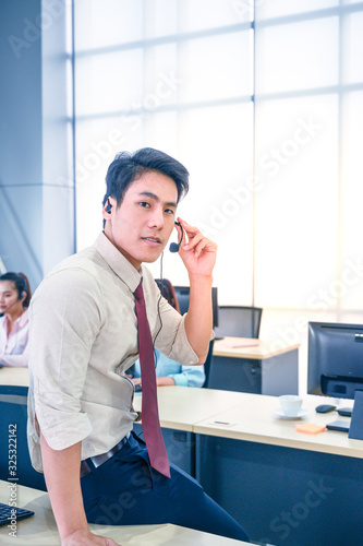Young customer service men agent with headsets and computer working at office.