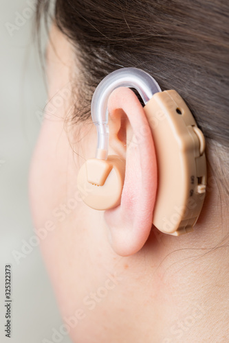 Close-up Of Hearing Aid In The Ear Of A Girl
