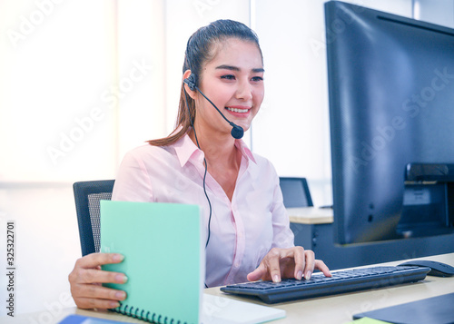 Young customer service women agent with headsets and computer working at office.