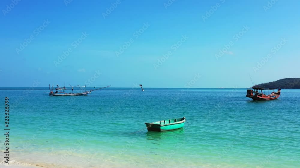 Topical Landscape blue sea with boats floating near the sandy beach Topical Landscape blue sea with boats floating near the sandy beach