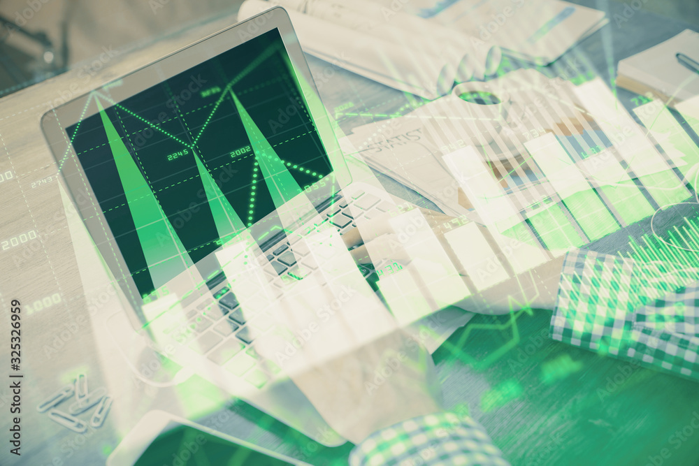 Double exposure of forex graph with man working on computer on background. Concept of market analysis.