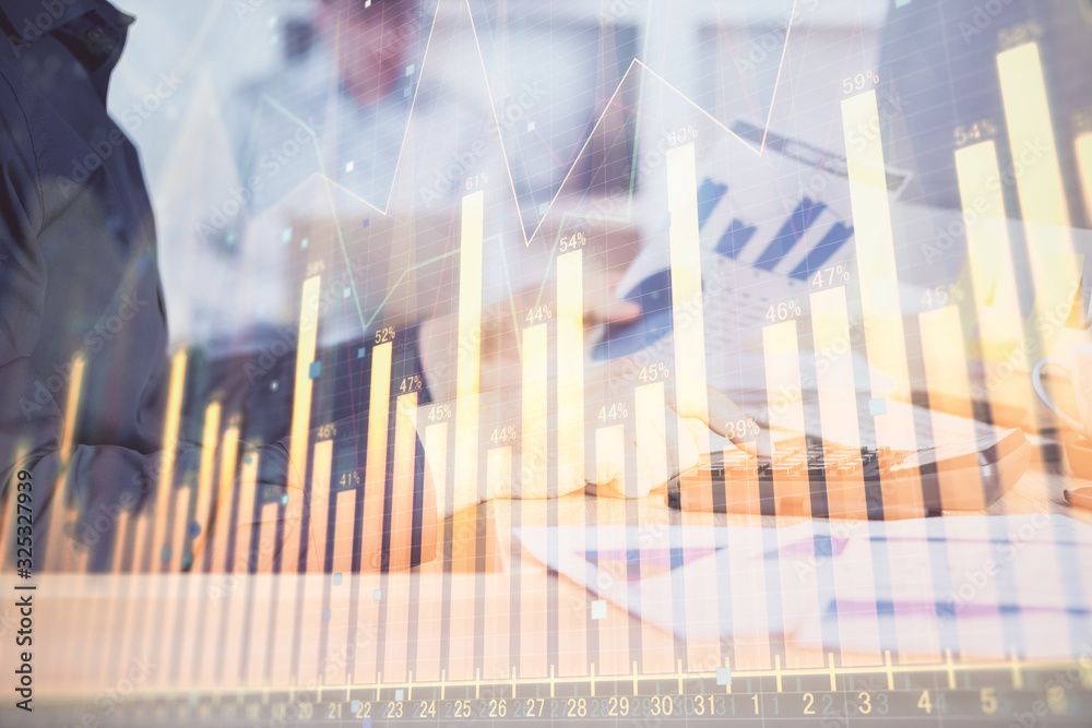 Double exposure of graph with man typing on computer in office on background. Concept of hard work. Closeup. Double exposure of graph with man typing on computer in office on background. Concept of hard work. Closeup.
