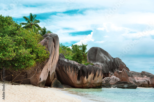 Famed for being one of the most photographed beaches on the planet Anse Source d'Argent at sunny summer day - beautiful and tropical coast in Indian ocean, Seychelles island