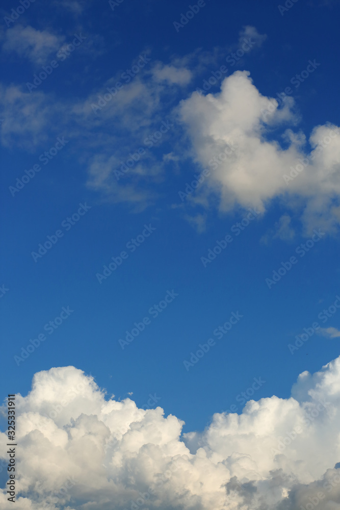 Obraz premium fluffy white cloud above clear blue sky background