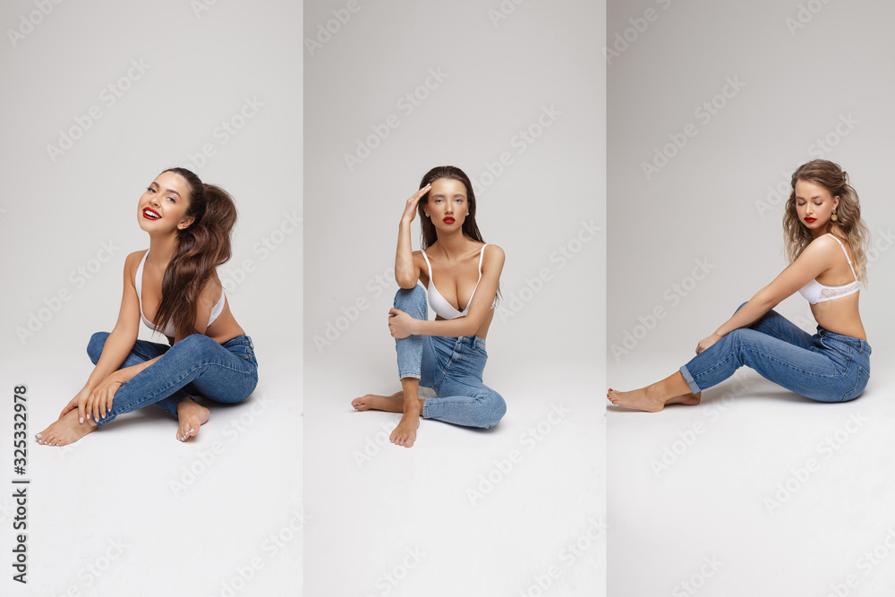 Three young smiling fashion model in bra and jeans posing isolated at white studio background. Group of attractive happy girl in lingerie rejoicing having positive emotion