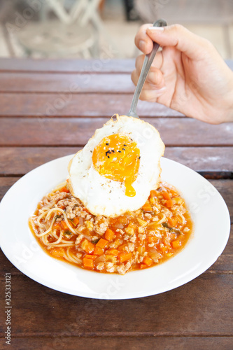 Italian spaghetti bolognese with tomato sauce and fried egg