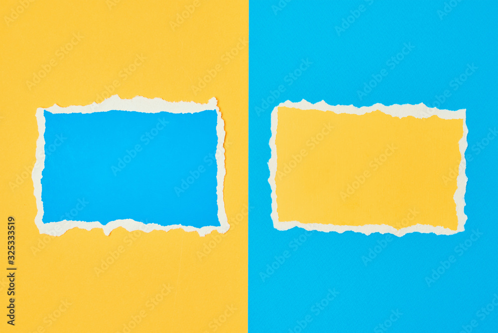 Two ripped paper torn edge sheets on a blue and yellow background. Template with piece of color paper