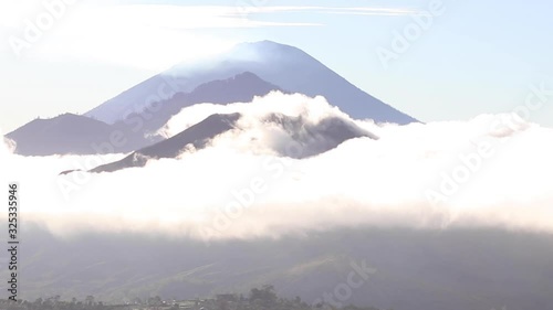 View of three bali volcanoes in the clouds at dawn. Agung, Batur and Abang