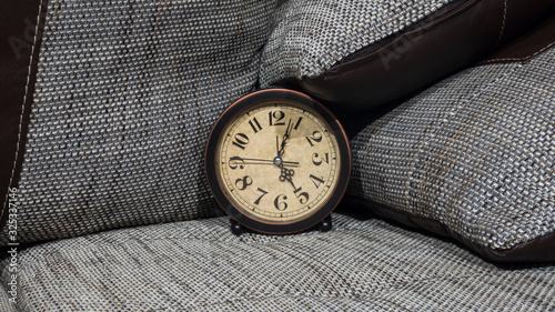 Summer Daylight Saving Time (DST) concept. Retro styled Clock with pillows.