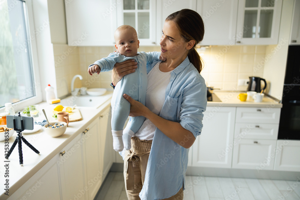 Happy woman enjoying time with her kid in the kitchen