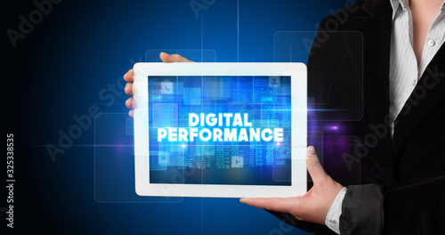 Wallpaper Mural Young business person working on tablet and shows the inscription: DIGITAL PERFORMANCE Torontodigital.ca