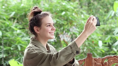 Young girl takes a selfie in nature