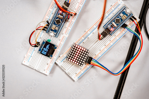 professional engineer assemble the details of device with pcb controller and counter with numbers photo