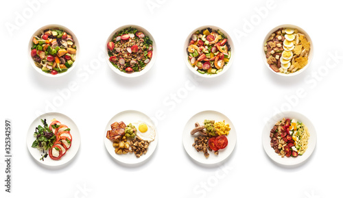 Top view of different salads on white background