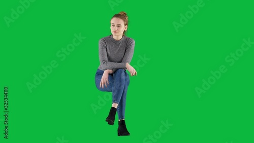 Casual Girl Sitting and Looking Around Waiting for Someone on Green Screen