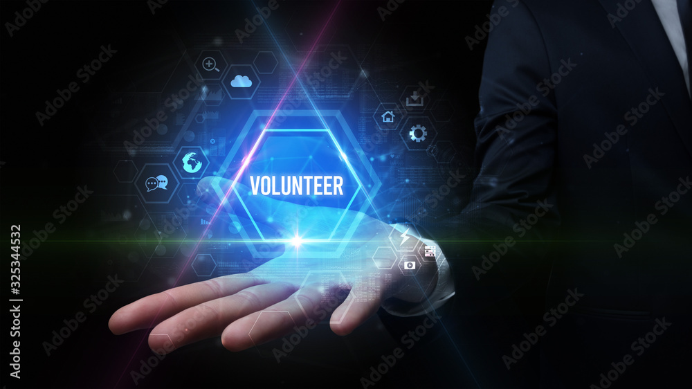 Man hand holding VOLUNTEER inscription, social media concept Man hand holding VOLUNTEER inscription, social media concept