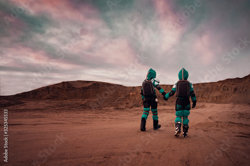 Two Astronauts Wearing Space Suits Holding Hands on Mars/ Red Planet. Love in Space Travel, Exploration and Colonization Concept.