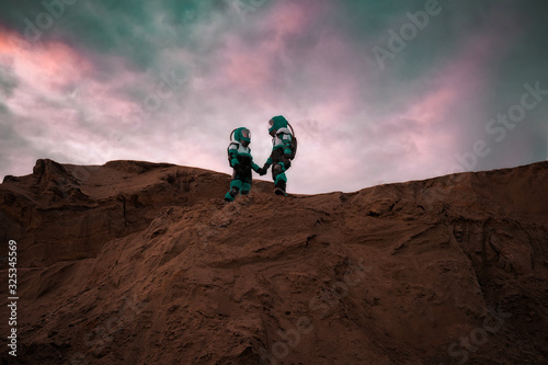 Two Astronauts Wearing Space Suits Holding Hands on Mars  Red Planet. Love in Space Travel  Exploration and Colonization Concept.