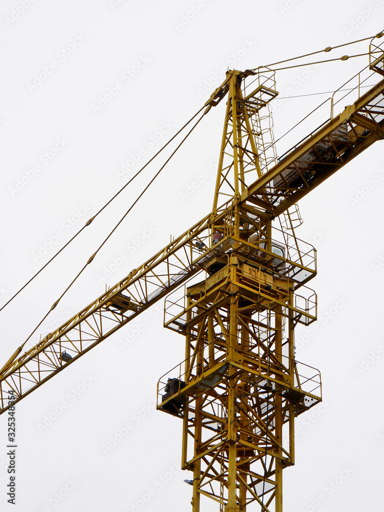 Crane. Self-erection crane against foggy sky.