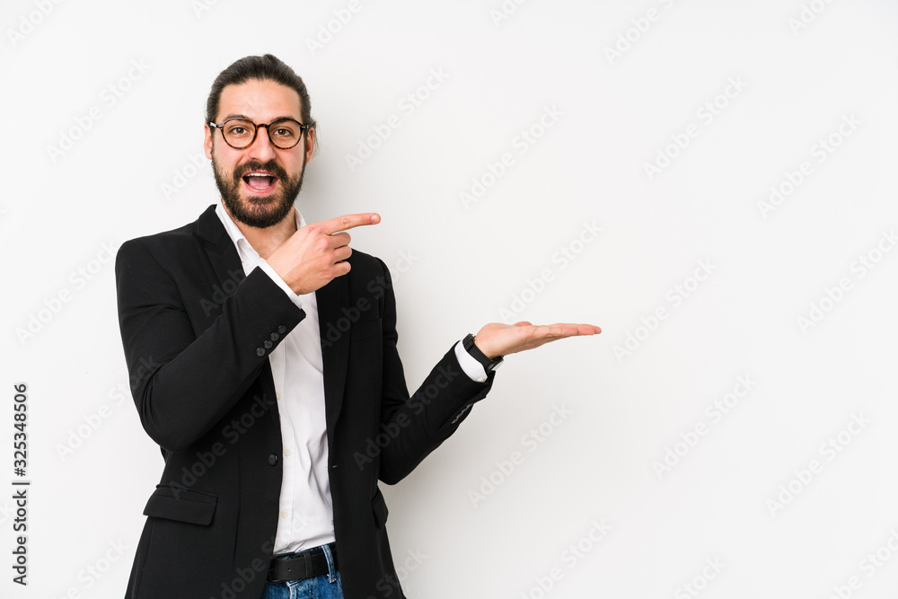 Young caucasian business man isolated on a white background excited holding a copy space on palm. Young caucasian business man isolated on a white background excited holding a copy space on palm.
