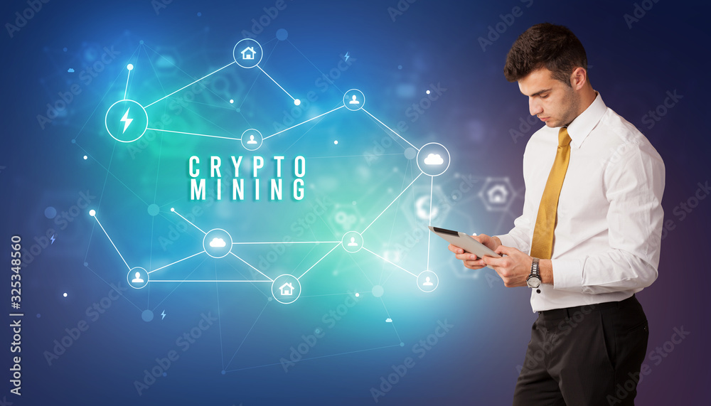 Businessman in front of cloud service icons with CRYPTO MINING inscription, modern technology concept Businessman in front of cloud service icons with CRYPTO MINING inscription, modern technology concept