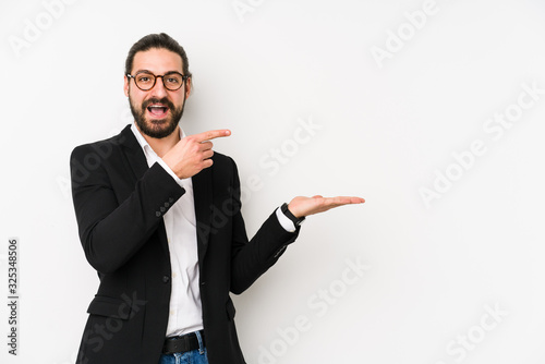 Young caucasian business man isolated on a white background excited holding a copy space on palm.