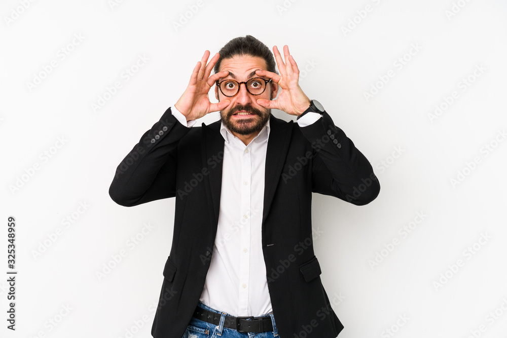 Young caucasian business man isolated on a white background keeping eyes opened to find a success opportunity. Young caucasian business man isolated on a white background keeping eyes opened to find a success opportunity.