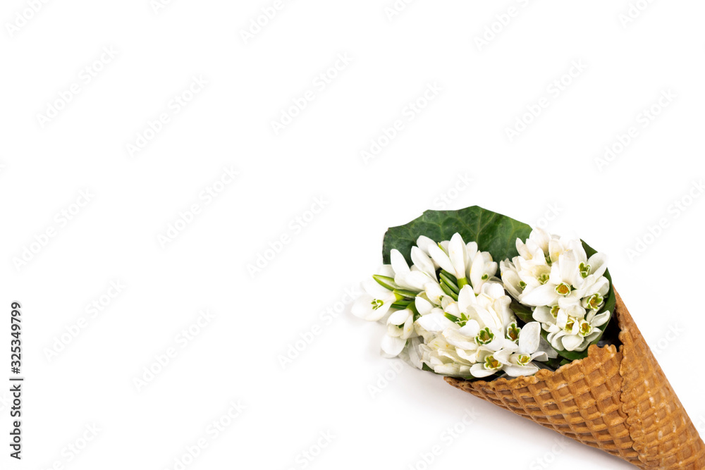 Ice cream waffle cone with spring flower wildflowers bouquet on white background. Spring and summer holiday minimal flat lay concept. Part of set.