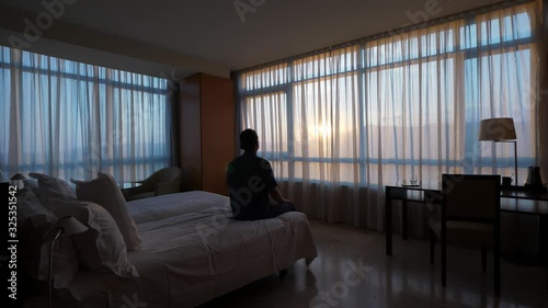 Excited Man sit down on bed