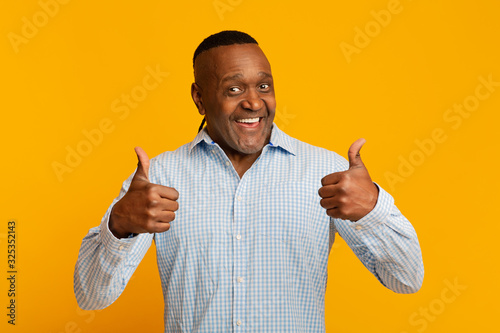 Enthusiastic mature afro american man gesturing thumbs up