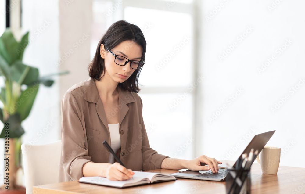 Portrait of concentrated manager writing in notebook Portrait of concentrated manager writing in notebook