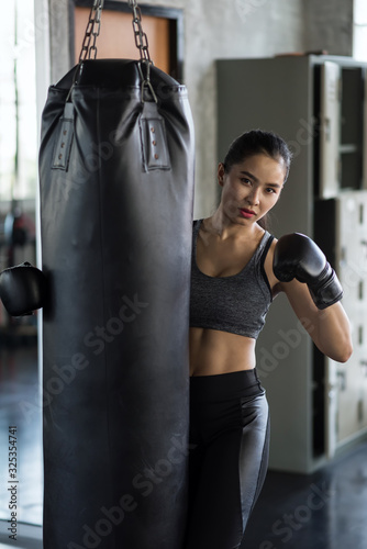 Sport woman hold punch bag in gym © Blanscape