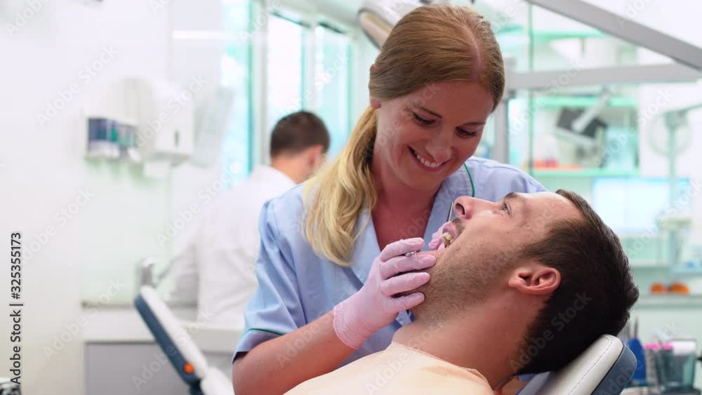 Female ginger dental doctor is checking her patient Female ginger dental doctor is checking her patient
