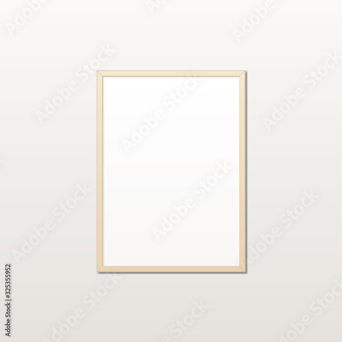 Realistic white poster in a wooden frame on a light wall