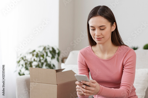 Happy girl received online shopping parcel and paying for it